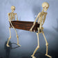 Skeletons Carrying a Coffin